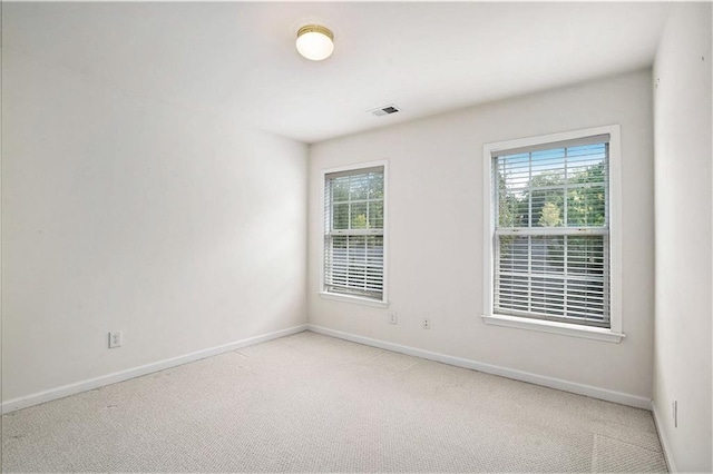 empty room featuring carpet flooring and a healthy amount of sunlight