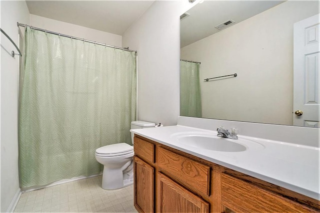 bathroom featuring walk in shower, vanity, and toilet