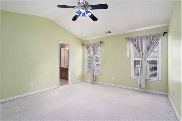 empty room featuring light carpet, lofted ceiling, and ceiling fan