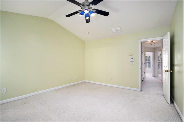 carpeted spare room featuring ceiling fan and lofted ceiling