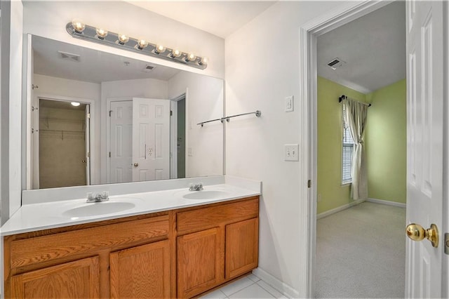 bathroom with tile patterned flooring and vanity