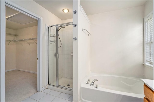 bathroom with tile patterned flooring, independent shower and bath, and vanity