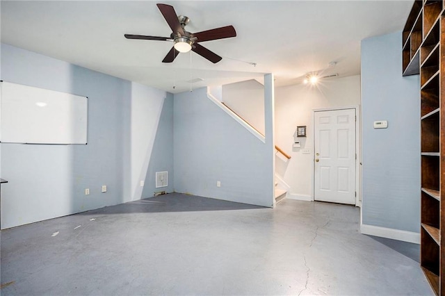 interior space with concrete floors and ceiling fan