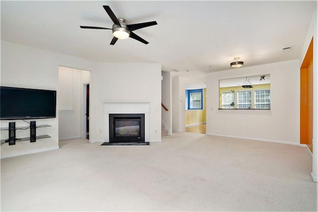 carpeted living room with ceiling fan