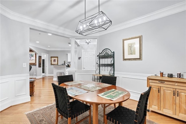 4100 Paces Walk SE Unit 2304, Atlanta, GA 30339 - dining room with a chandelier, ornamental molding, decorative columns, a wainscoted wall, and light wood finished floors