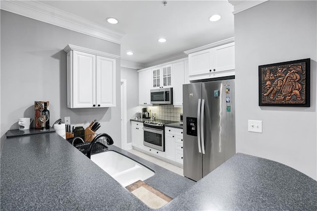 4100 Paces Walk SE Unit 2304, Atlanta, GA 30339 - kitchen with stainless steel appliances, ornamental molding, a sink, white cabinetry, and decorative backsplash