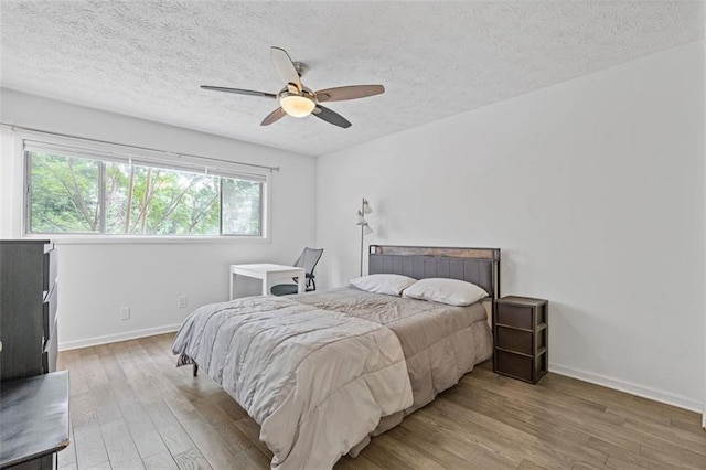 3236 Henderson Mill Rd Unit 1, Chamblee, GA 30341 - bedroom with wood finished floors, a textured ceiling, and ceiling fan