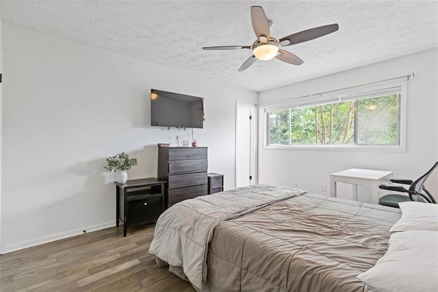 3236 Henderson Mill Rd Unit 1, Chamblee, GA 30341 - bedroom featuring wood finished floors, a textured ceiling, and ceiling fan