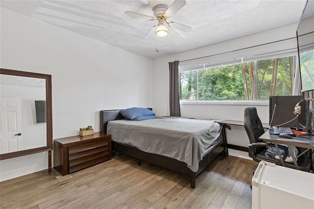 3236 Henderson Mill Rd Unit 1, Chamblee, GA 30341 - bedroom featuring light wood finished floors, a textured ceiling, an office area, and ceiling fan