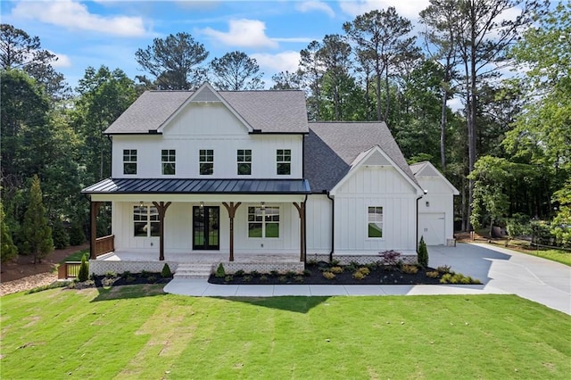 10350 Alvin Rd, Johns Creek, GA 30022 - modern farmhouse with board and batten siding, a standing seam roof, concrete driveway, covered porch, and a front yard