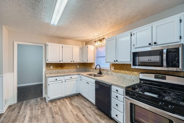 kitchen with white cabinets, stainless steel appliances, and sink