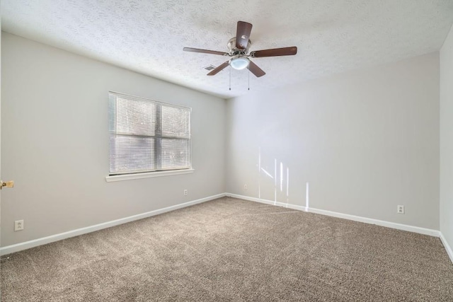 carpeted empty room featuring ceiling fan and a textured ceiling