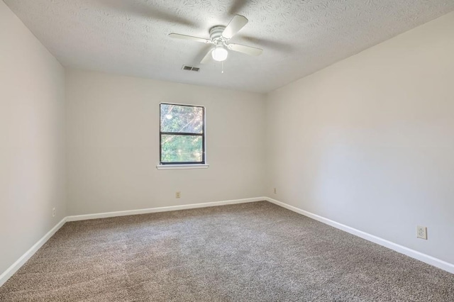 unfurnished room with carpet flooring, ceiling fan, and a textured ceiling