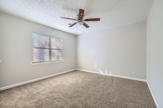 carpeted spare room featuring ceiling fan and a textured ceiling