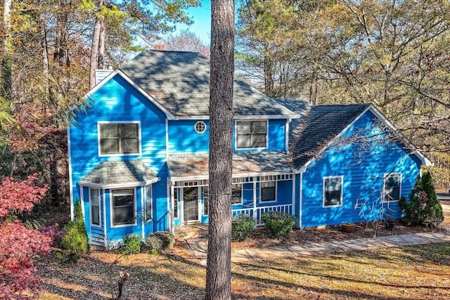 view of front of property with a front yard and a porch