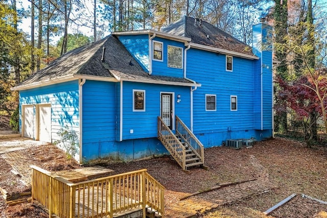 rear view of house with a garage