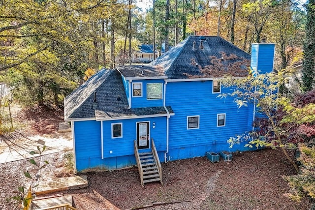 rear view of house featuring central AC