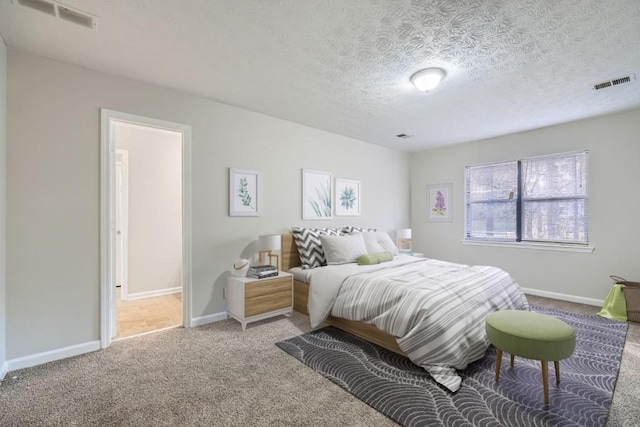 bedroom with carpet floors and a textured ceiling