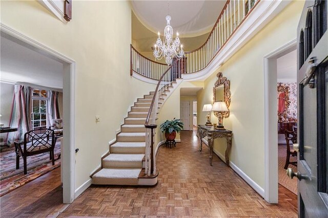 3456 Paces Pl NW, Atlanta, GA 30327 - foyer featuring baseboards, a towering ceiling, stairway, and a chandelier