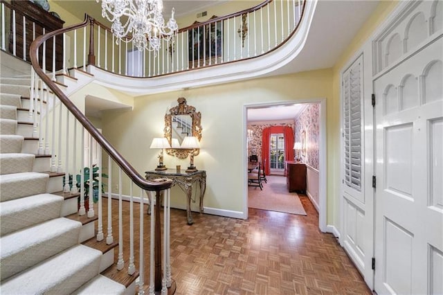 3456 Paces Pl NW, Atlanta, GA 30327 - foyer featuring baseboards, stairway, a chandelier, and a towering ceiling