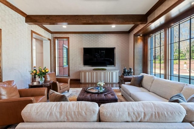 living area with a healthy amount of sunlight, wood finished floors, and wallpapered walls