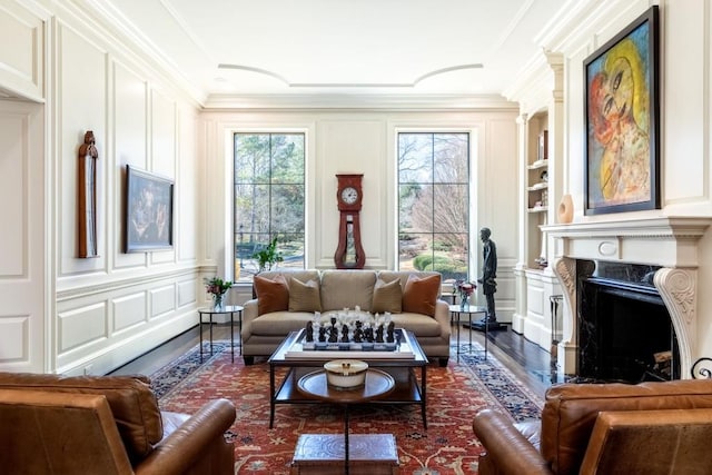 living room with plenty of natural light, crown molding, and a decorative wall