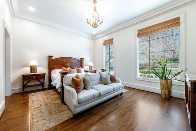 bedroom with wood finished floors, recessed lighting, an inviting chandelier, crown molding, and baseboards