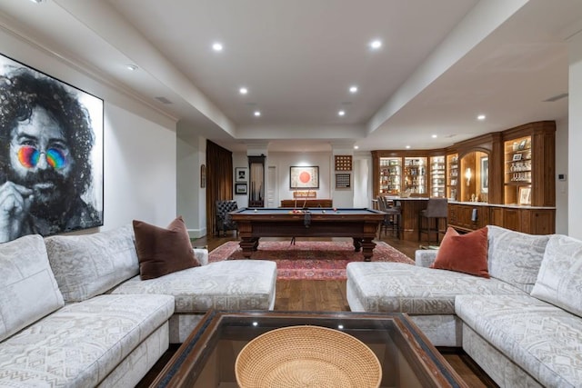 recreation room with recessed lighting, wet bar, a raised ceiling, wood finished floors, and billiards