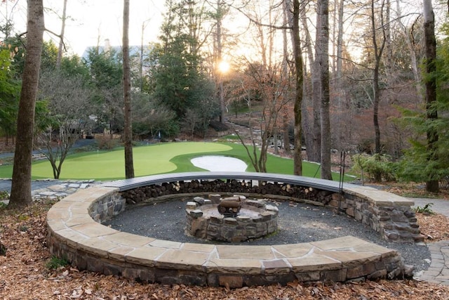 view of home's community with an outdoor fire pit