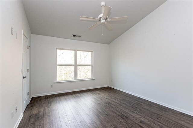 empty room with ceiling fan and dark hardwood / wood-style floors