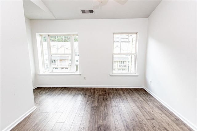 empty room featuring wood-type flooring and ceiling fan