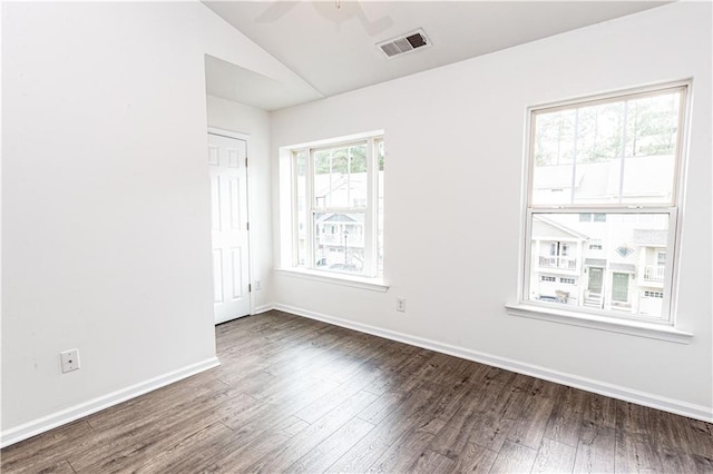 spare room with ceiling fan, lofted ceiling, and dark hardwood / wood-style floors