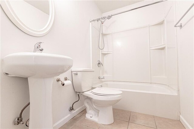 bathroom featuring tile patterned flooring, tub / shower combination, and toilet