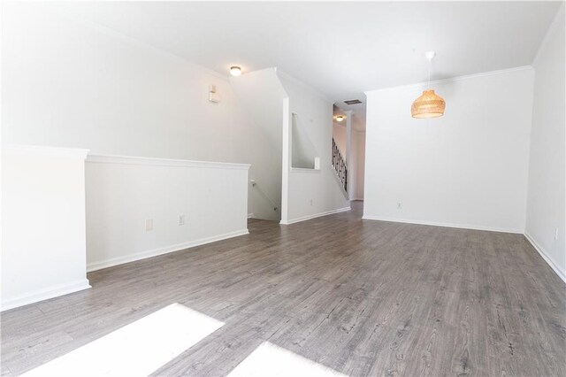 unfurnished living room featuring crown molding, dark hardwood / wood-style floors, and french doors