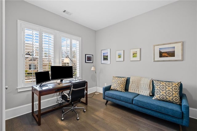 office space with visible vents, wood finished floors, and baseboards