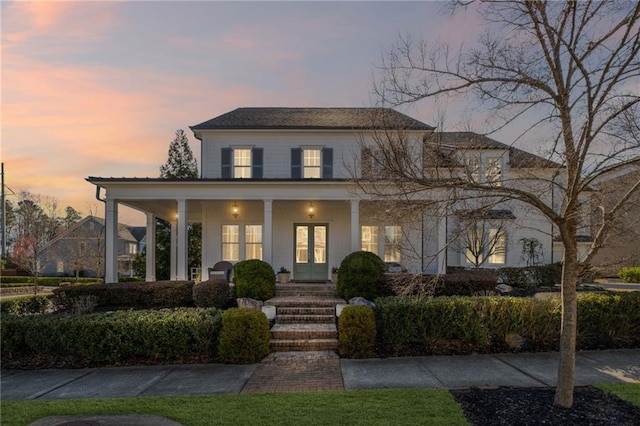 view of front of property with french doors and a porch