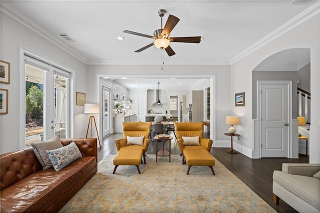 living room featuring baseboards, stairway, ornamental molding, recessed lighting, and wood finished floors