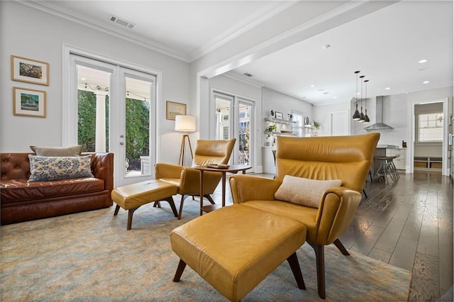 living area featuring visible vents, recessed lighting, french doors, wood-type flooring, and crown molding