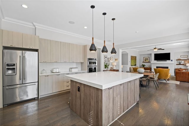 kitchen featuring backsplash, modern cabinets, appliances with stainless steel finishes, and ornamental molding