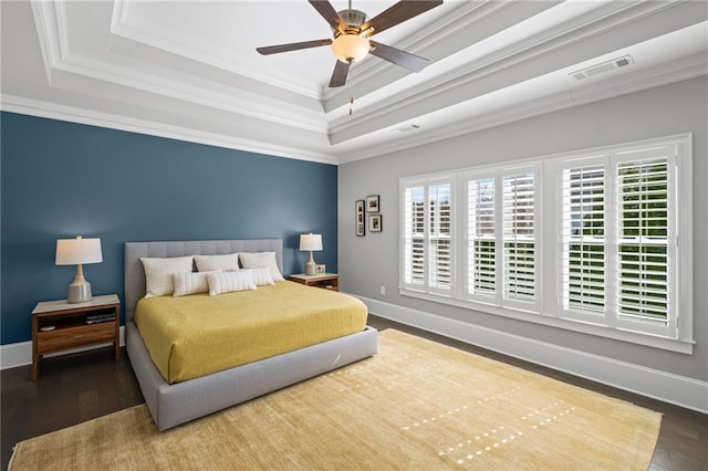 bedroom with visible vents, baseboards, crown molding, and a tray ceiling