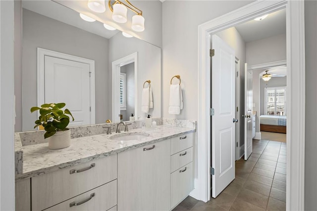 bathroom with ensuite bath, tile patterned flooring, vanity, and ceiling fan