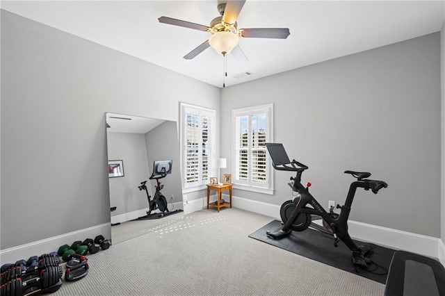 exercise room with carpet flooring, baseboards, visible vents, and a ceiling fan