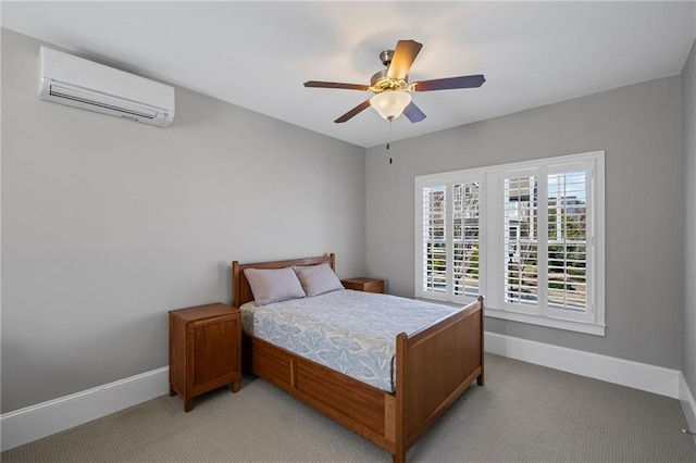 bedroom with a wall mounted air conditioner, baseboards, light colored carpet, and a ceiling fan