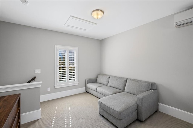 living area with carpet flooring, attic access, a wall mounted air conditioner, and baseboards