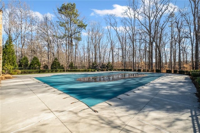 view of swimming pool featuring a patio and a fenced in pool