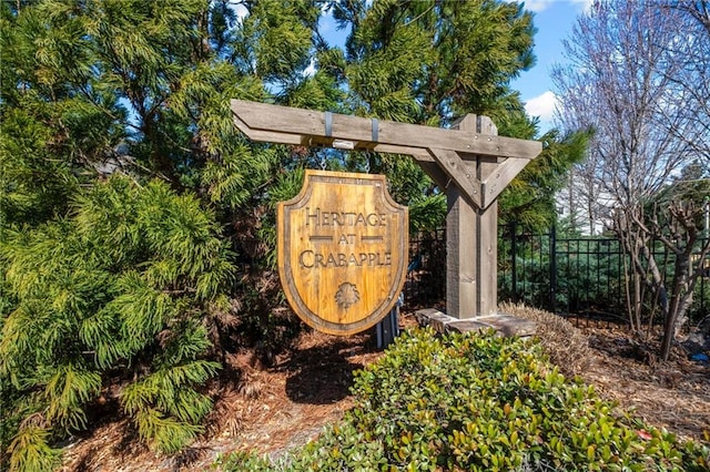 community sign featuring fence