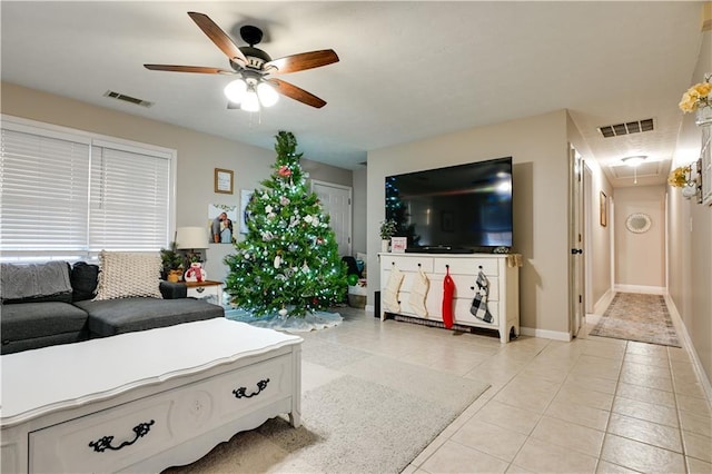 tiled living room with ceiling fan