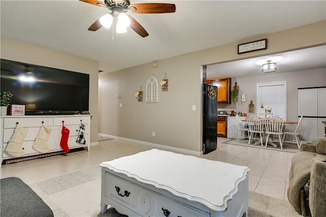 living room featuring ceiling fan and light tile patterned flooring