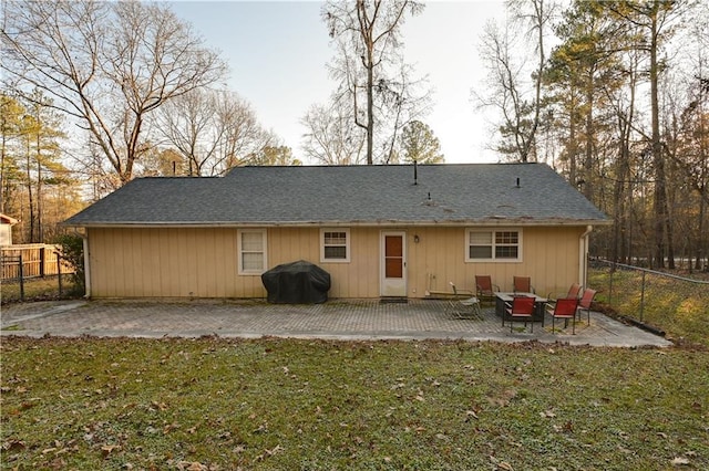 back of house with a yard and a patio