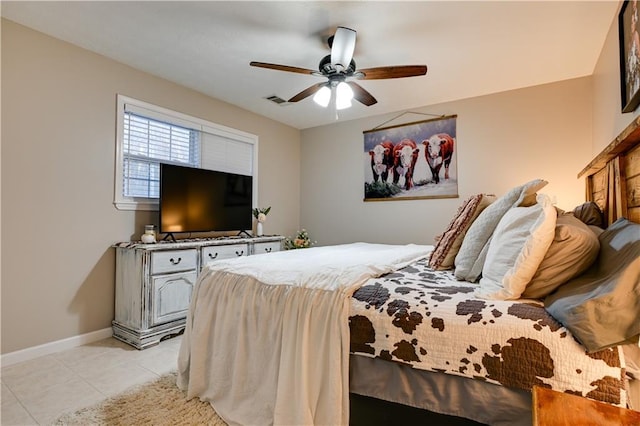 tiled bedroom featuring ceiling fan